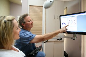 Dr. Vandewater examines a dental x-ray with a patient.